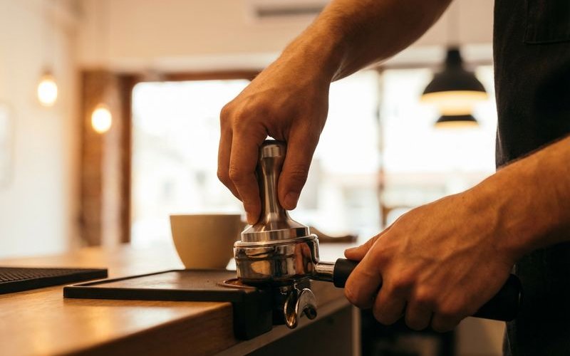 Barista crafting a specialty coffee drink at Bubbs & Bites Cafe